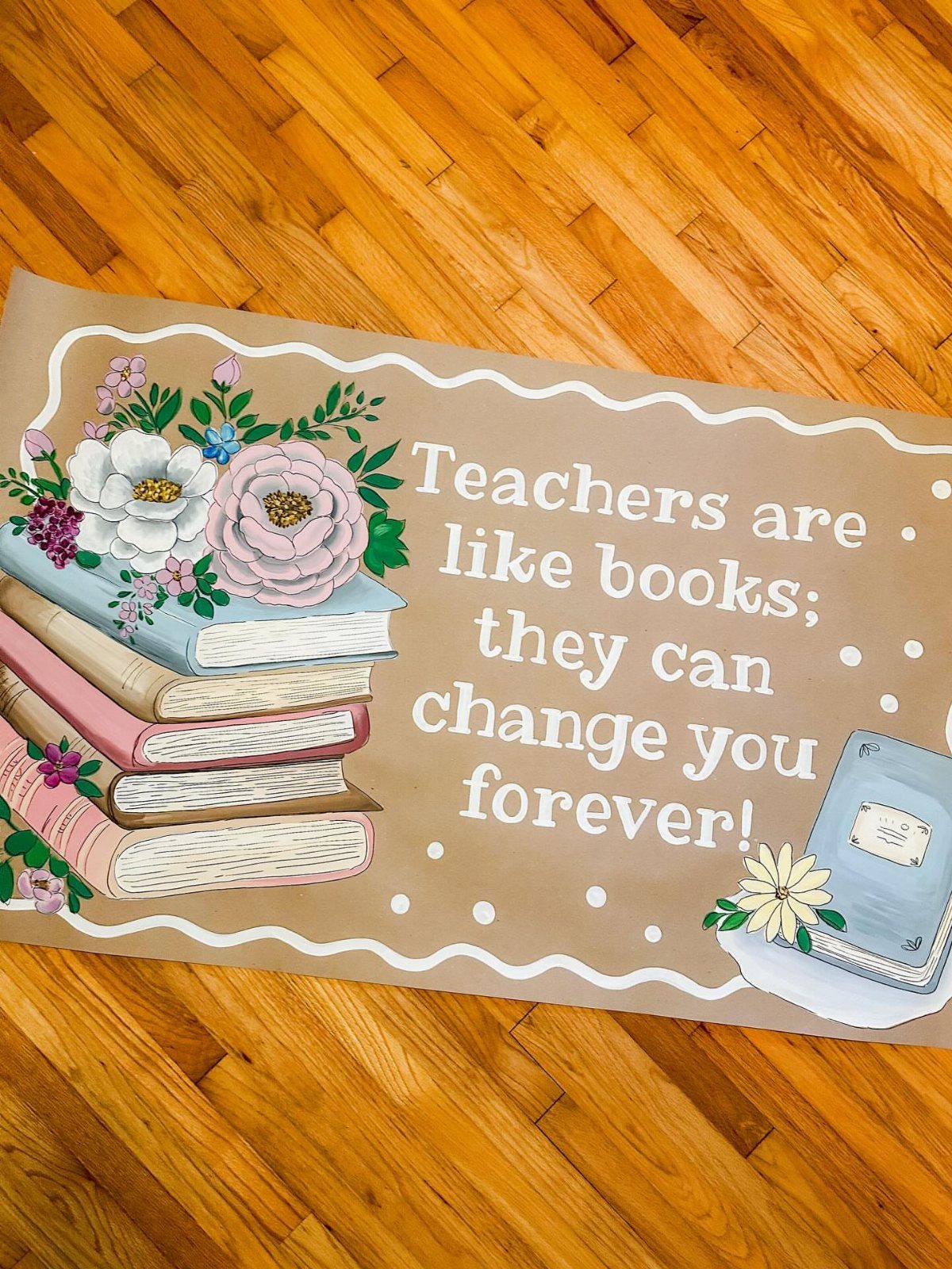 Brown teacher appreciation banner with book illustrations and a gratitude quote on wood.