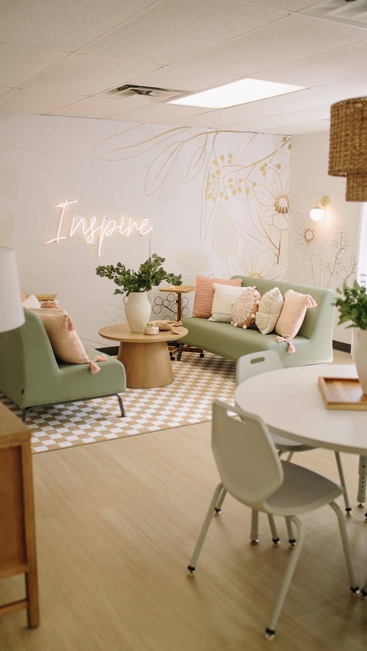 Mint green sofa and armchair in a serene lounge with neon Inspire sign.
