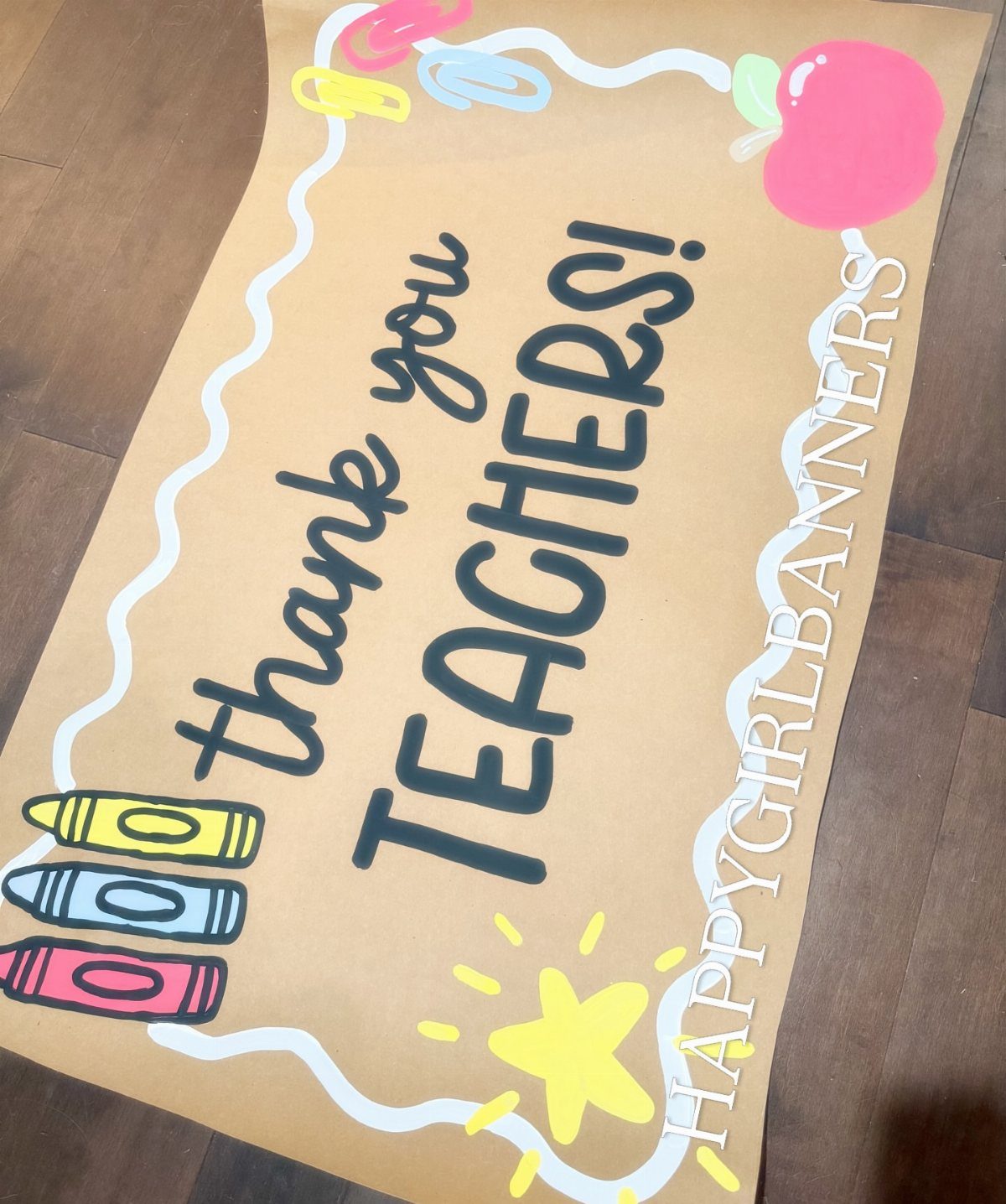 Brown paper banner saying thank you teachers with colorful school-themed illustrations.