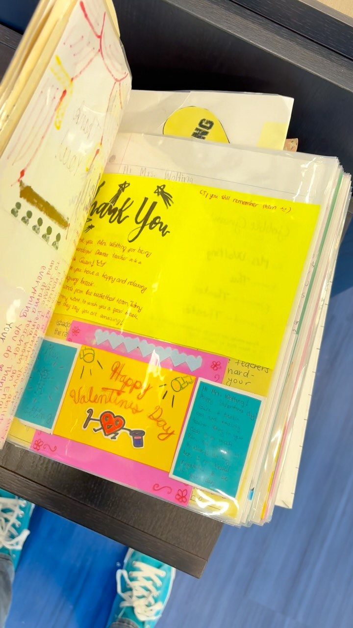 Open binder containing colorful handwritten thank you notes and a Valentine's Day card.