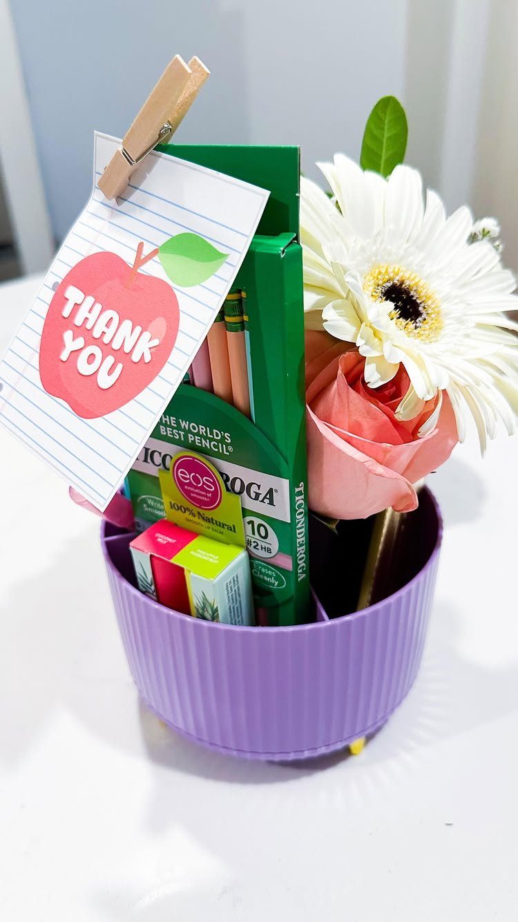 Purple gift basket with pencils, flowers, and a thank you apple note.
