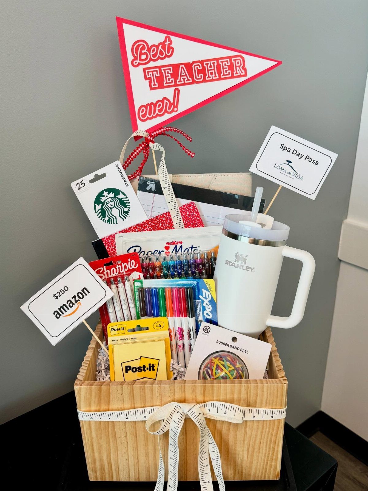 Wooden gift basket filled with school supplies, gift cards, and a teacher pennant.