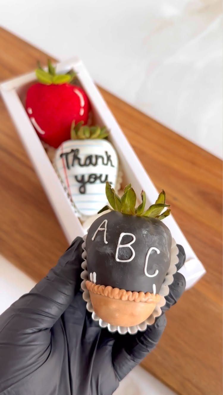 Chocolate-dipped strawberries decorated with ABCs and Thank You in a white box.