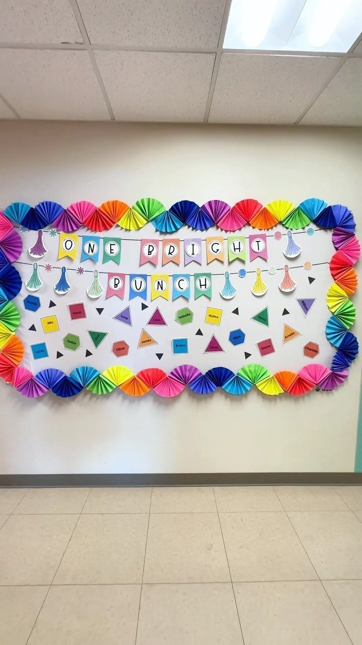 Colorful classroom wall display with rainbow paper fans and a bright bunch banner.