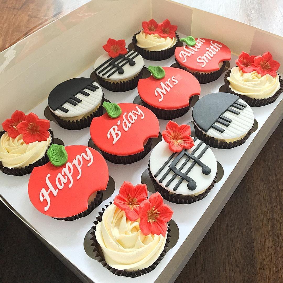 Teacher themed cupcakes with red apples, piano keys, and musical notes in a box