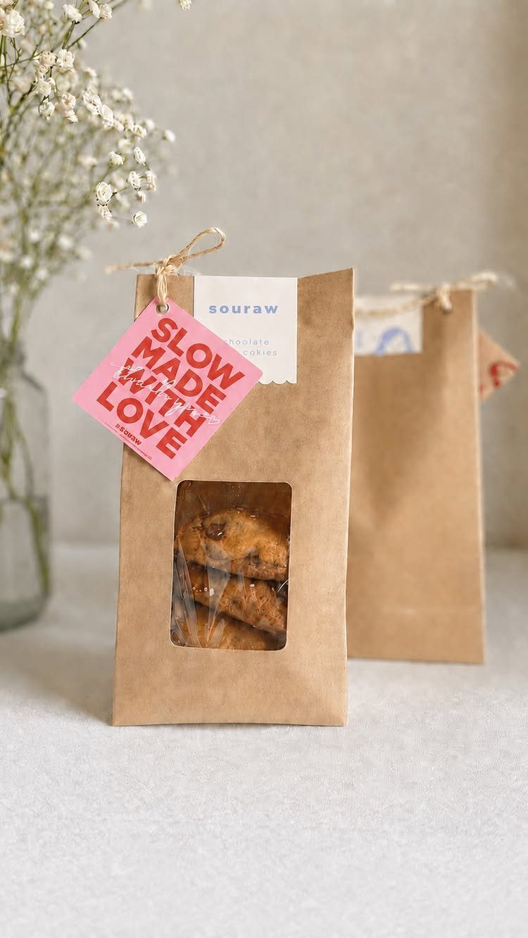 Chocolate chip cookies in brown paper bags with a pink love tag.