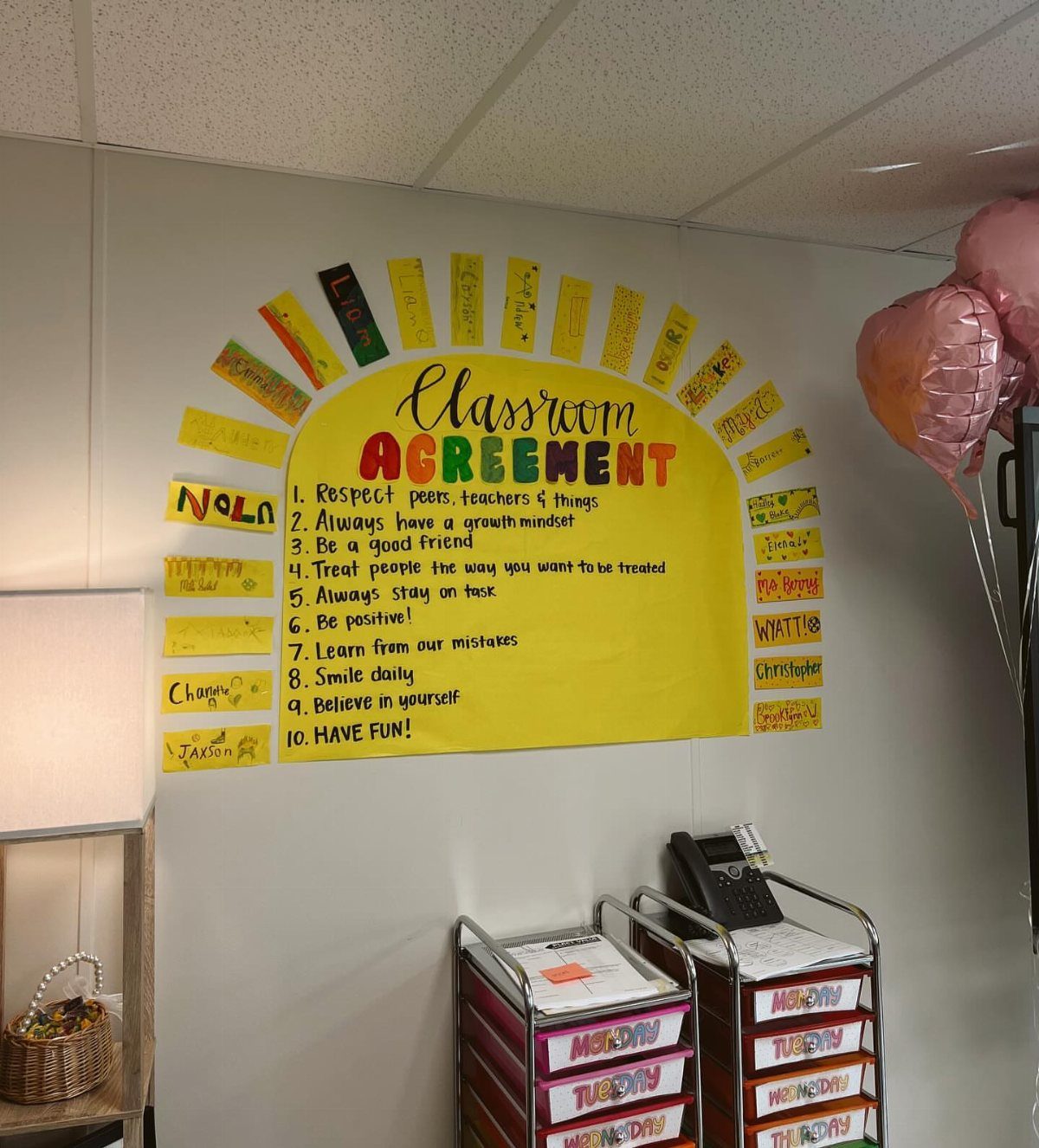 Classroom Agreement poster with ten rules and student names on a white wall.