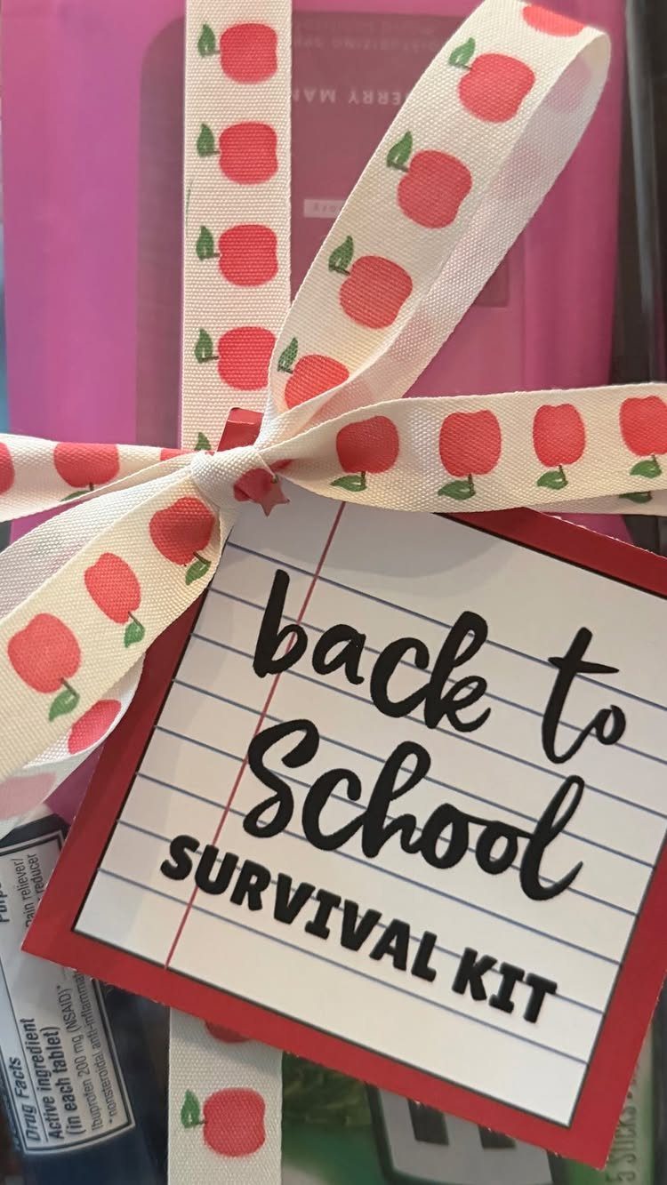 Pink gift container with apple ribbon and a back to school survival kit tag.