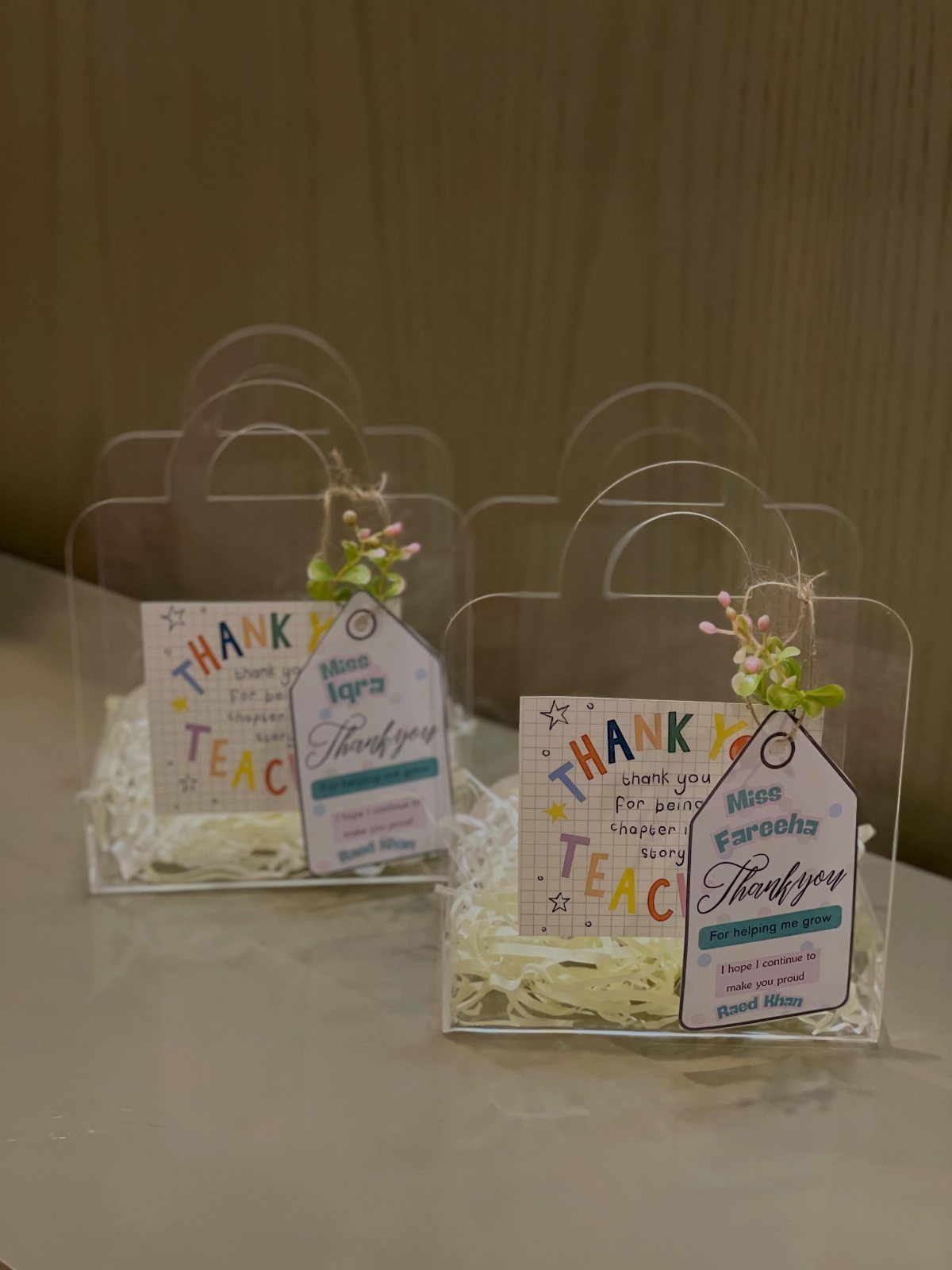 Clear plastic gift bags for teachers with thank you cards and personalized tags.