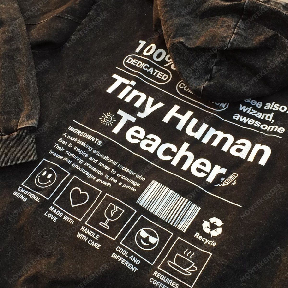 Dark grey acid-wash hoodie with white Tiny Human Teacher graphic print and icons.