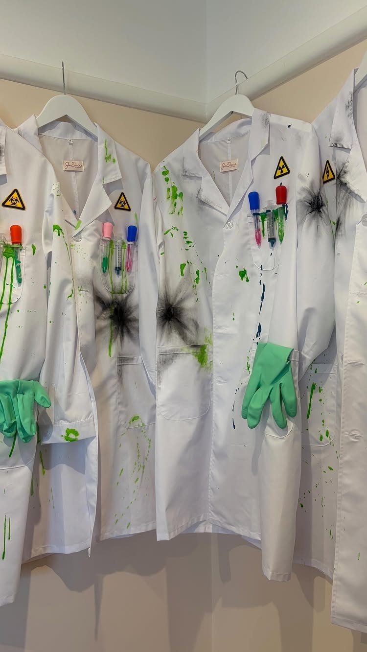 White lab coats with green splatters, biohazard signs, and test tubes for costumes.