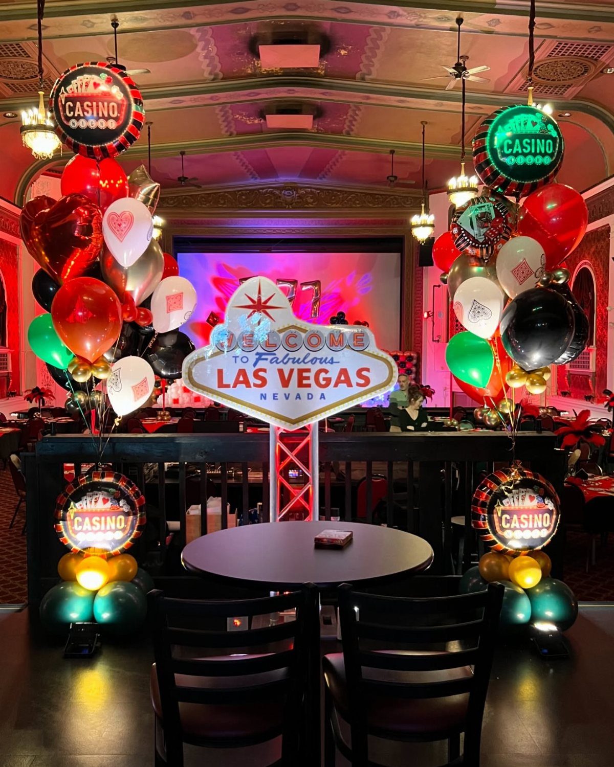 Las Vegas themed decorations with a welcome sign, balloons, and casino motifs.