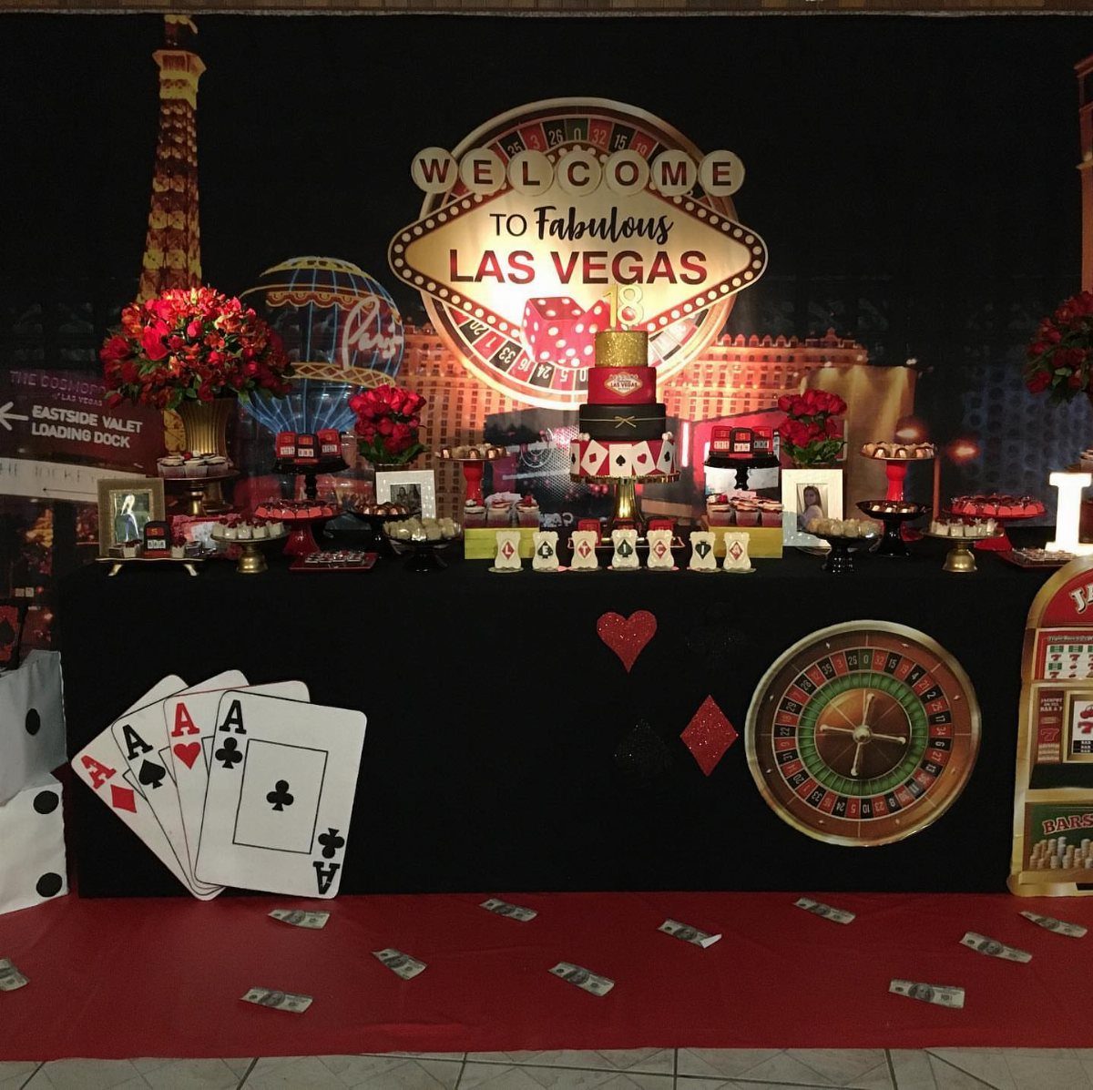 Las Vegas themed dessert table with red carpet and iconic welcome sign backdrop.