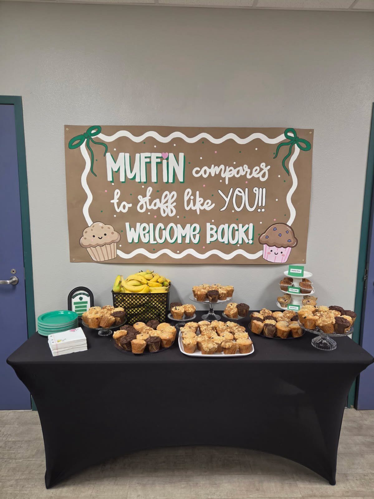 Muffins and bananas on a table with a welcome back staff sign.